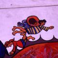Mural al santuario di Madonna di Briano. Particolare: un bambino con le ali di farfalla gioca sul drago della pace.
